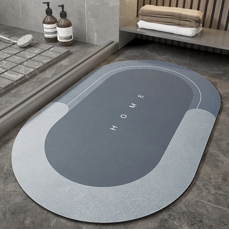 Machine-woven blended bathroom floor mat in blue, shown in an oval shape on a tiled floor.