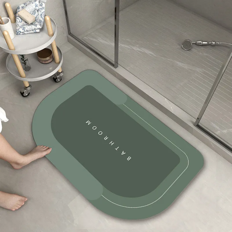 Machine-woven blended bathroom floor mat in blue, shown in an oval shape on a tiled floor.