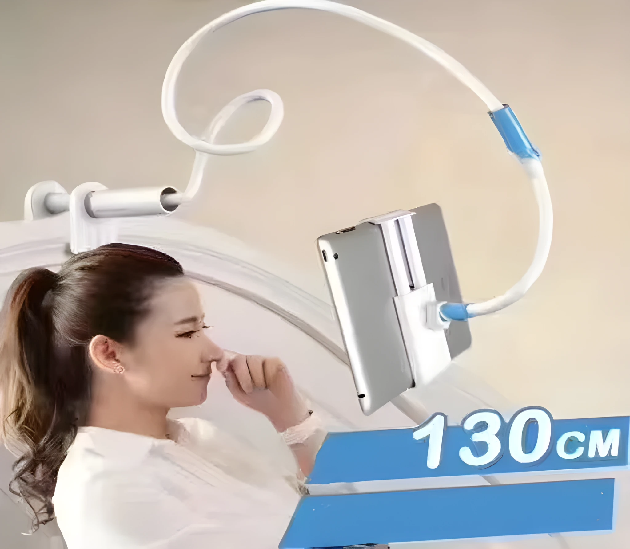 Blue universal mobile phone holder with 120cm pole clamped to bedside table holding a tablet