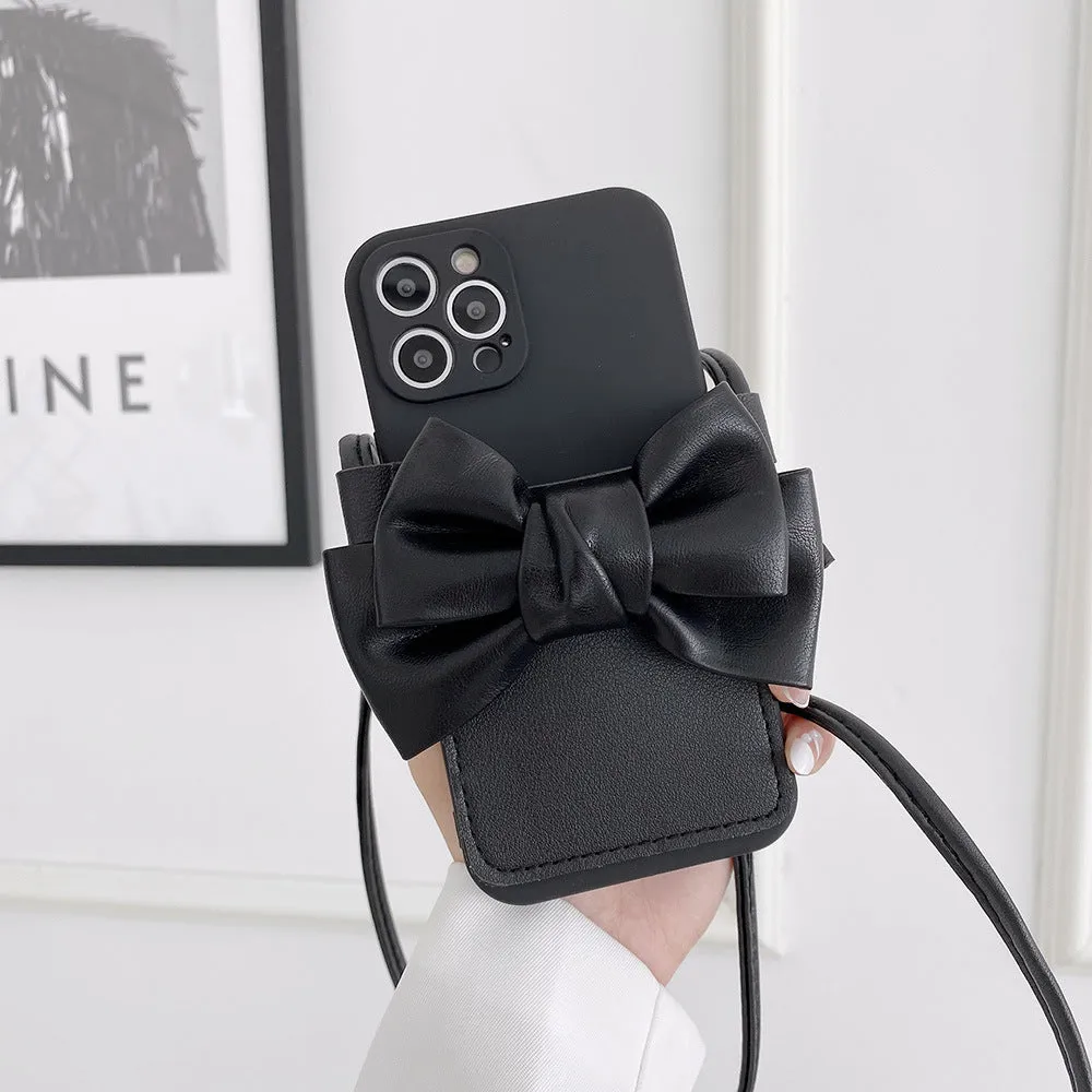 Ladies crossbody bag phone case in black with bow and strap showing iPhone in case front view