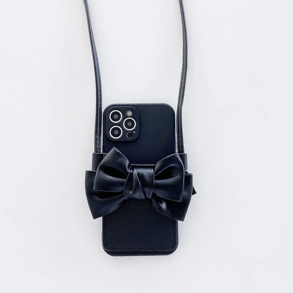 Ladies crossbody bag phone case in black with bow and strap showing iPhone in case front view