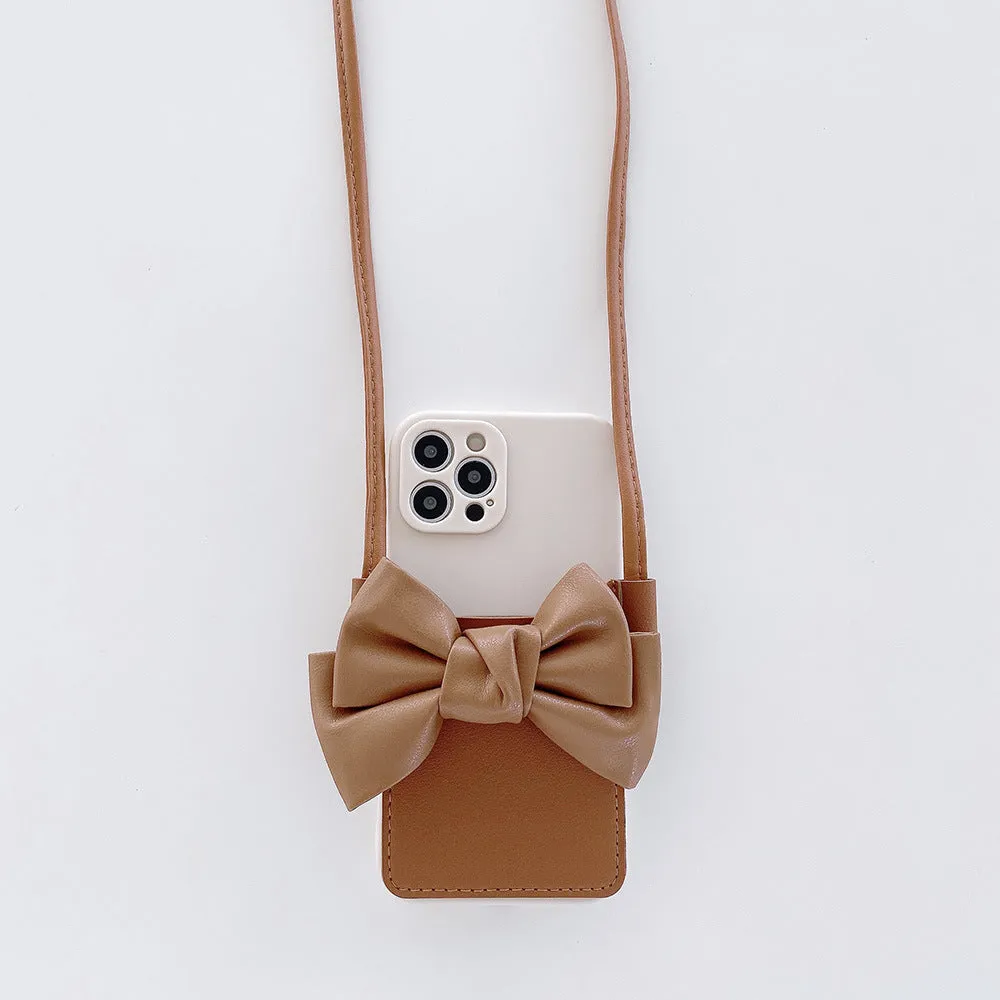 Ladies crossbody bag phone case in black with bow and strap showing iPhone in case front view