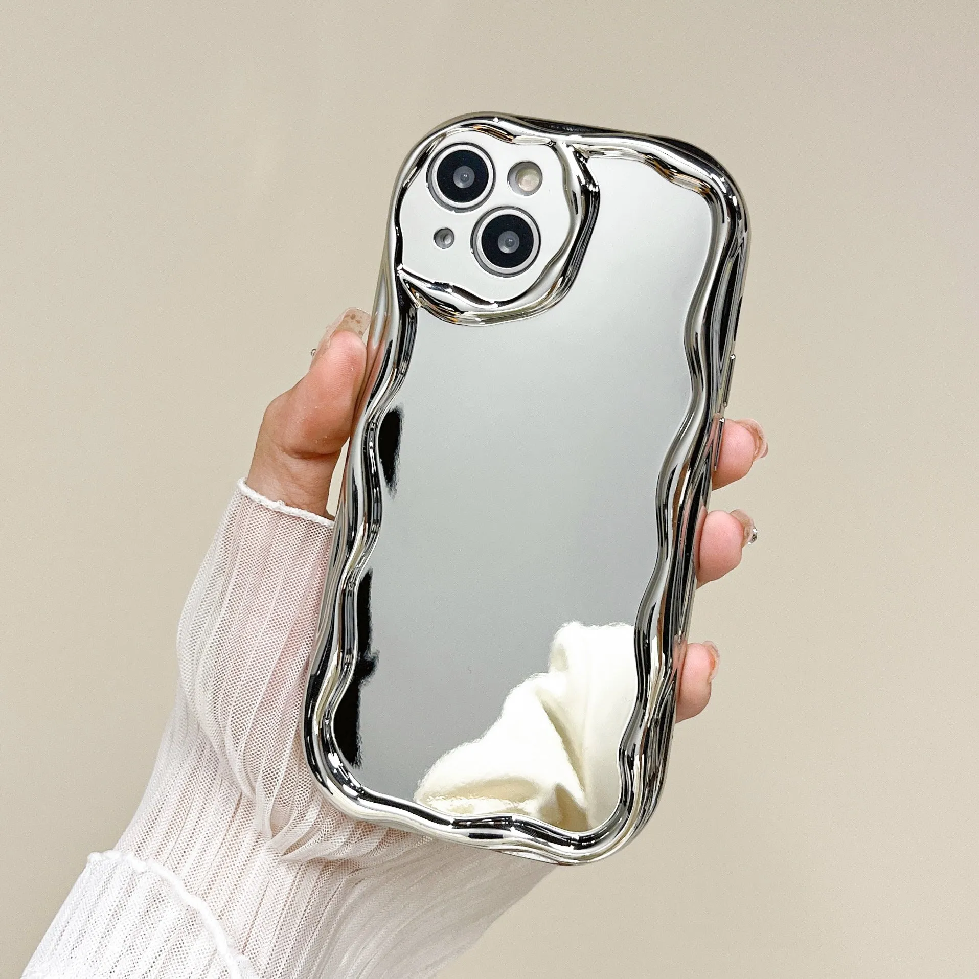 Silver electroplated cream grain silicone phone case with bracelet on a white background