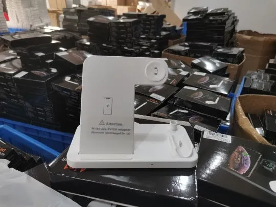 Foldable 4-in-1 wireless charging station in black, showing vertical phone stand and multiple charging pads for devices.