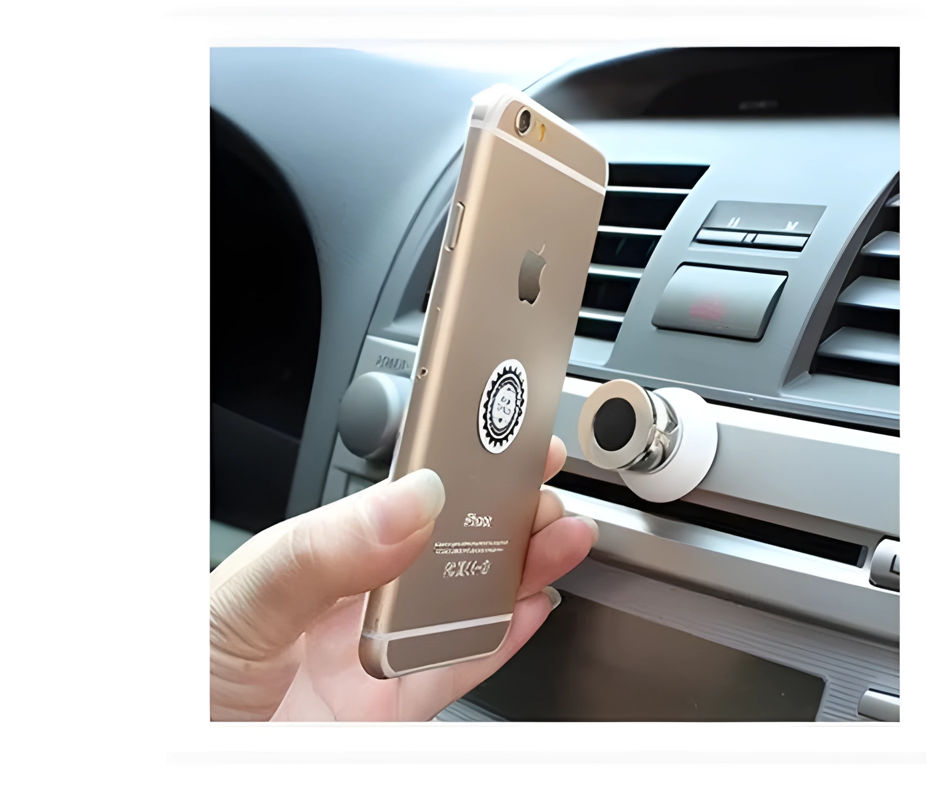 Magnetic car phone mount with paste base in black holding a Samsung phone on dashboard