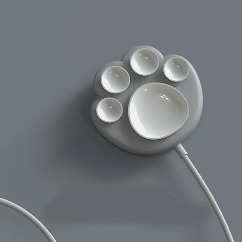 Pink cat claw sucker wireless charger with USB cable on a desk