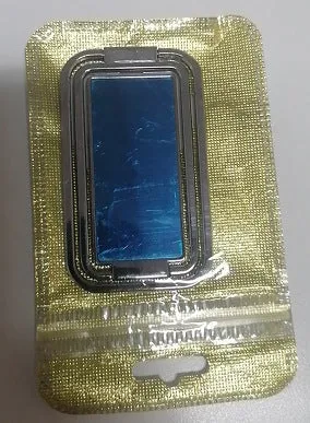 Folding double ring metal phone holder in silver with square buckle, open on a desk holding a smartphone