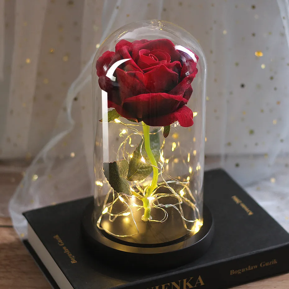 Artificial silk rose LED ornament with glass lampshade showing warm white lights, available in multiple colours.