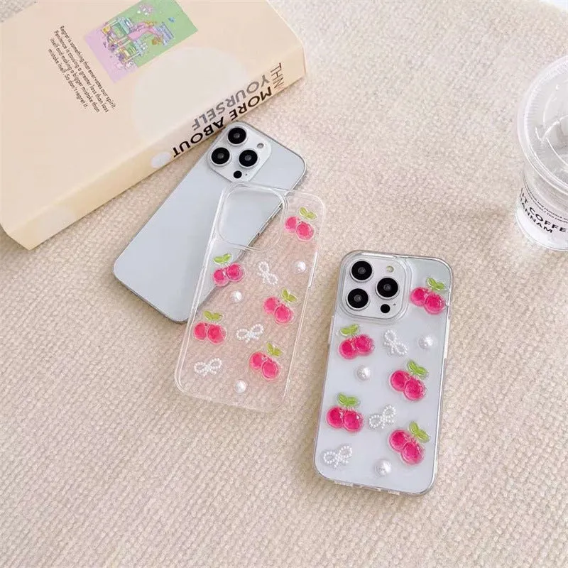 Epoxy three-dimensional cherry bow phone case in transparent finish showing decorative cherry and bow design on front