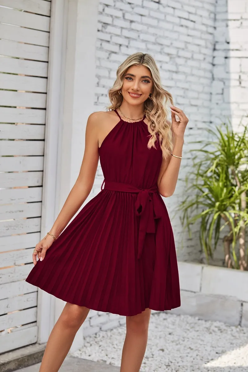 Women's black halter neck strapless sundress with a pleated chiffon skirt and an adjustable waist belt.
