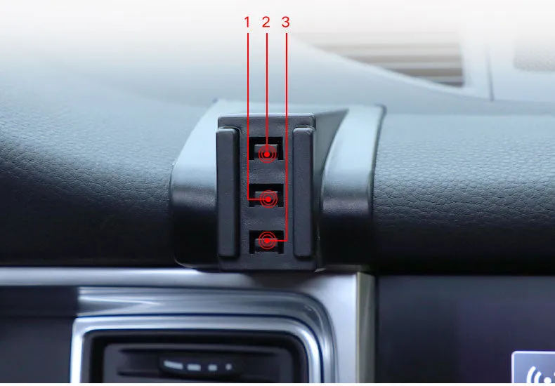 Gravity linkage car phone holder for Porsche in black alloy and carbon fibre, with phone mounted for navigation