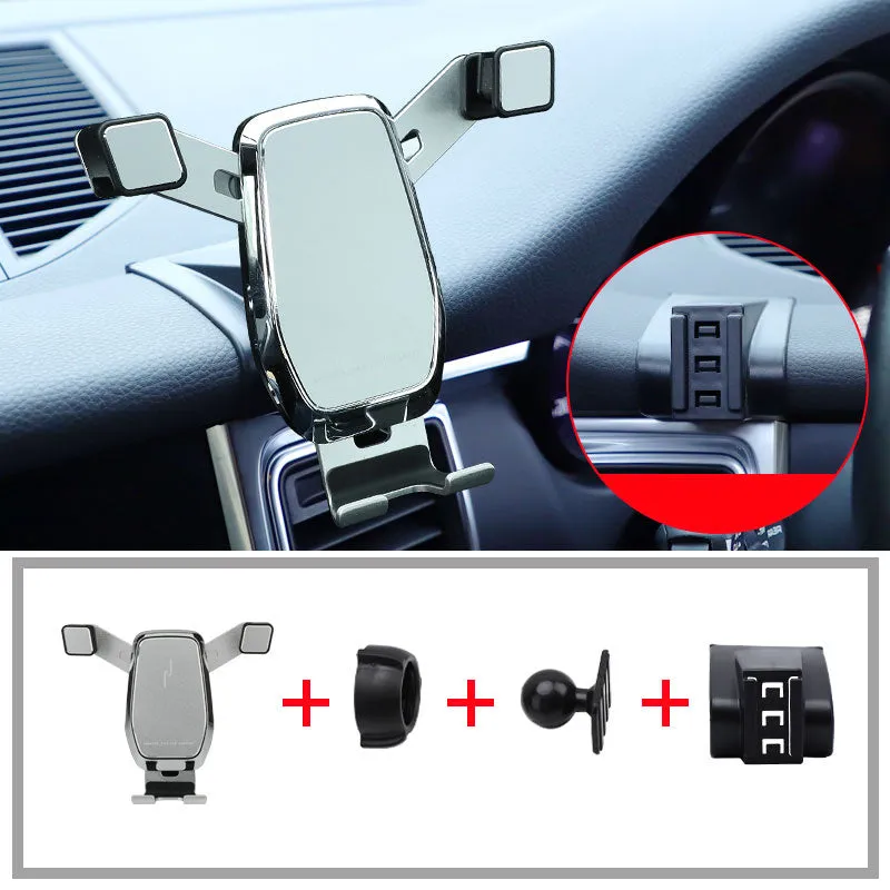 Gravity linkage car phone holder for Porsche in black alloy and carbon fibre, with phone mounted for navigation