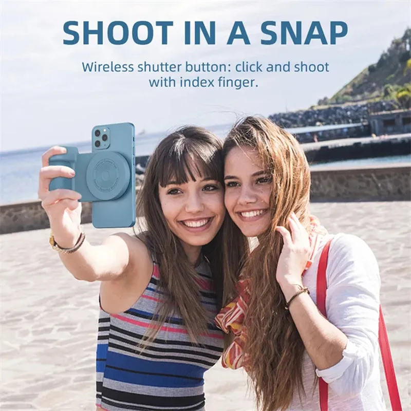 Black magnetic phone camera grip with rotatable stand and ergonomic PU leather handle on a table.