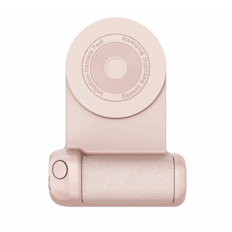 Black magnetic phone camera grip with rotatable stand and ergonomic PU leather handle on a table.