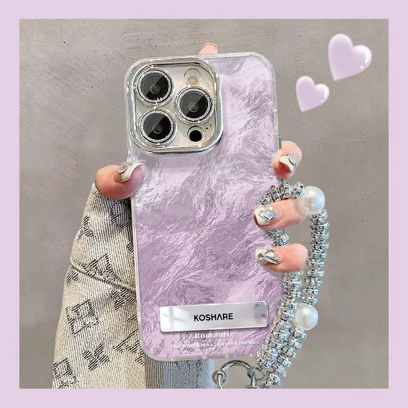 Ice blue gradient hard PC phone case with invisible bracket and silver chain for iPhone set on a white surface