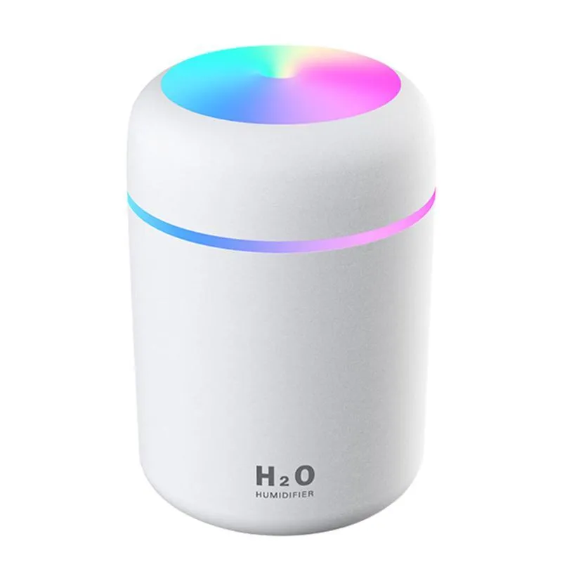 Pink USB desktop humidifier with coloured LED lights and water tank on a wooden desk.