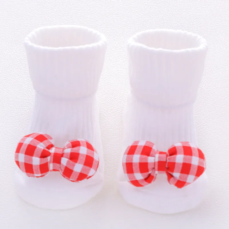 Cotton baby floor socks in various colours and patterns including pink bows, grey stars, and panda design.