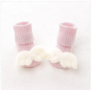 Cotton baby floor socks in various colours and patterns including pink bows, grey stars, and panda design.