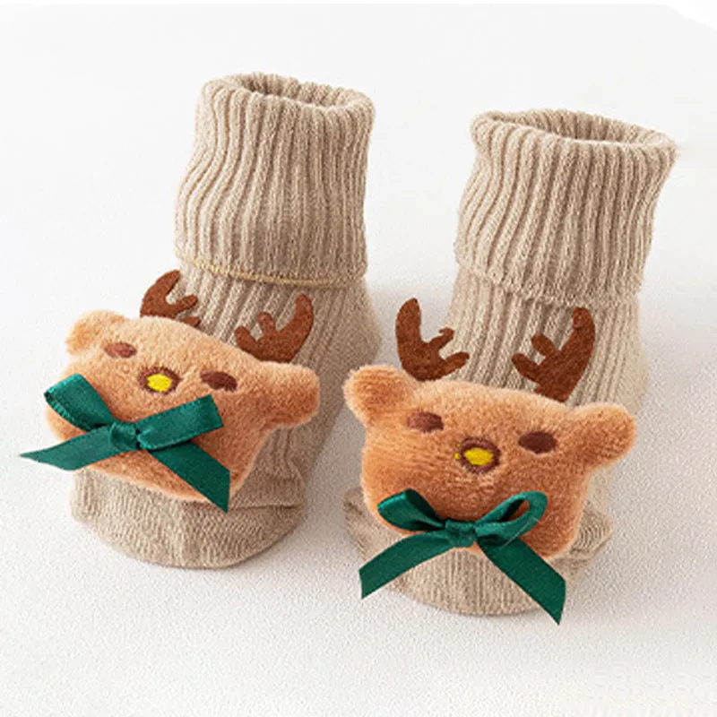 Cotton baby floor socks in various colours and patterns including pink bows, grey stars, and panda design.