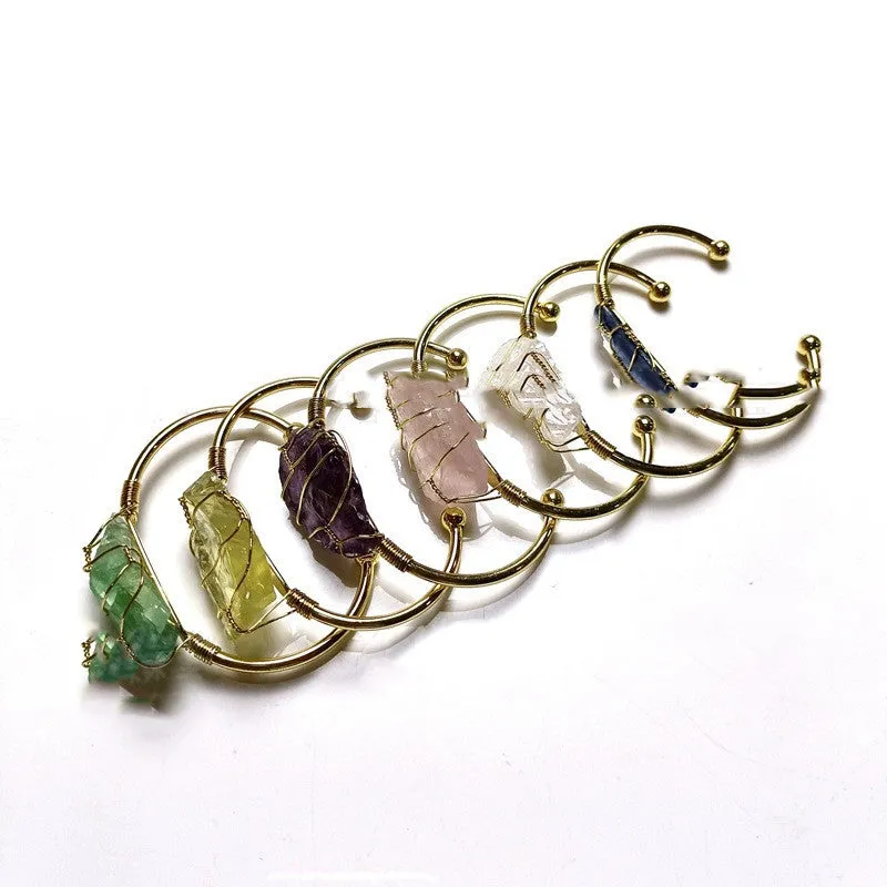 Unisex geometric bracelet made from rough natural crystals with gold metal winding.