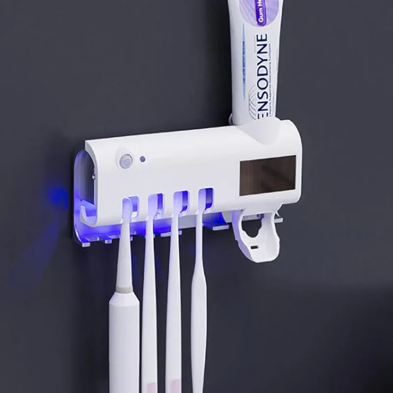 Black intelligent UV toothbrush steriliser with automatic toothpaste squeezer mounted on bathroom wall