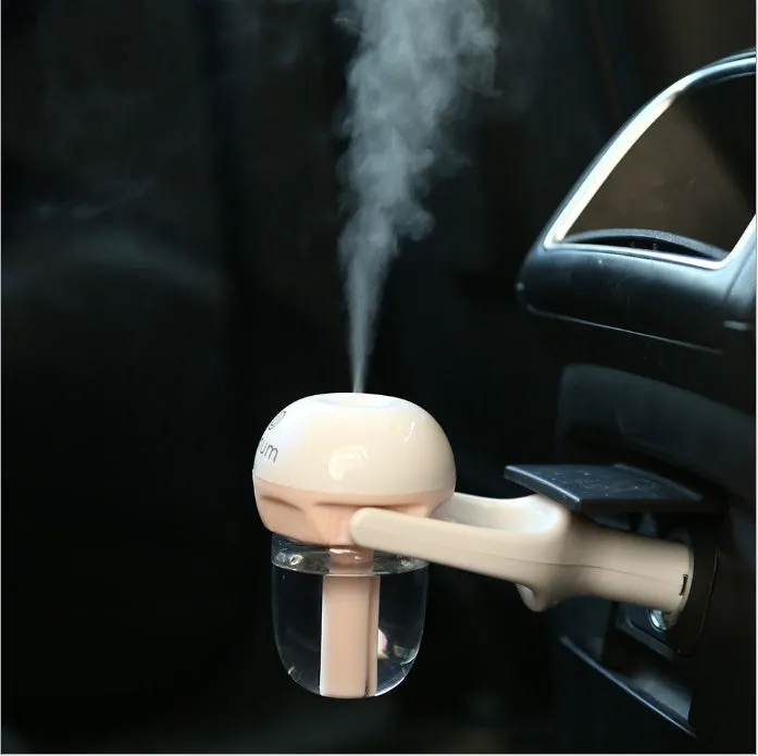 Blue portable car humidifier with rotating nozzle on a car dashboard