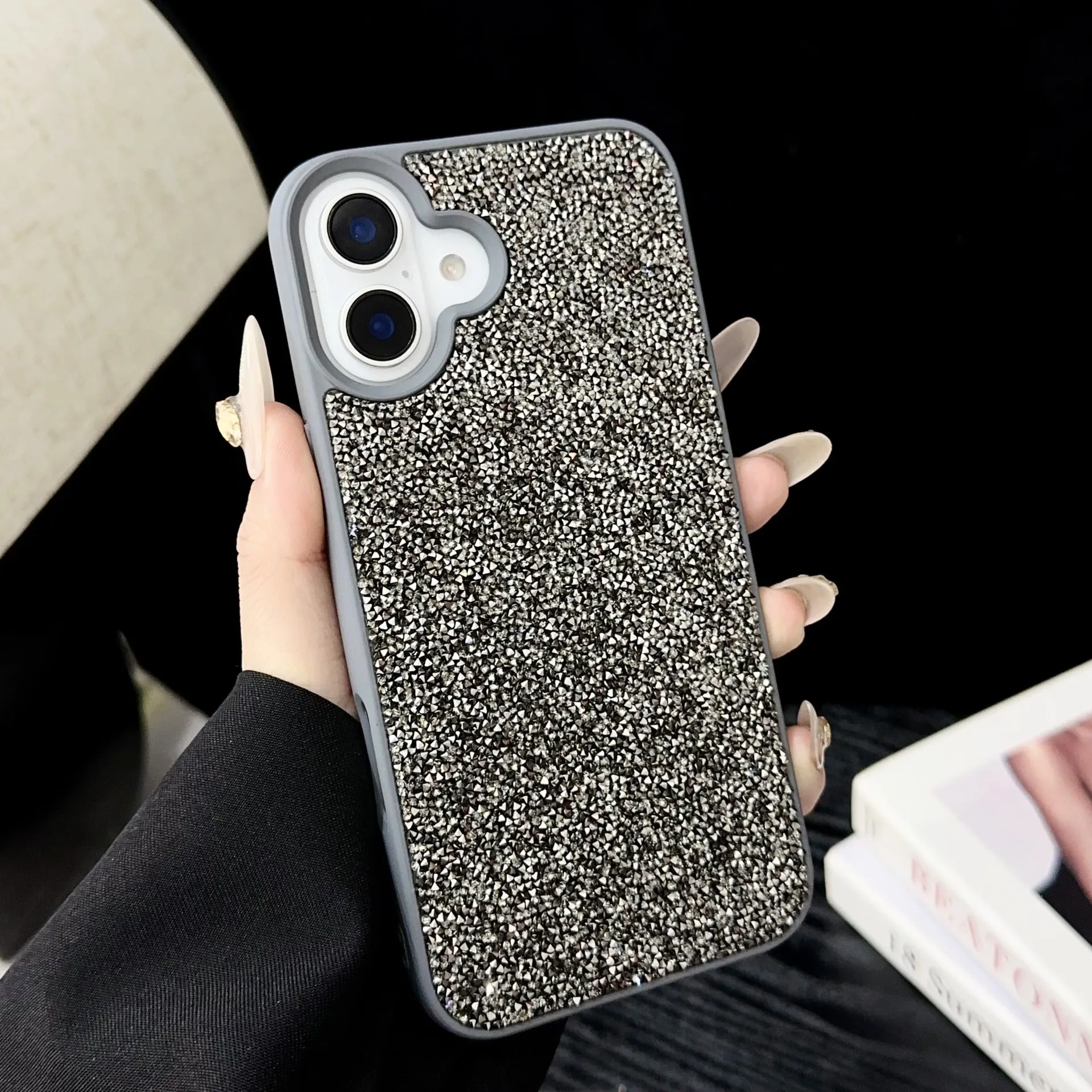 Skin Feeling Carbink phone case for iPhone 14 Pro with large hole cutouts and handmade rhinestone decorations in white, black, and pink colours