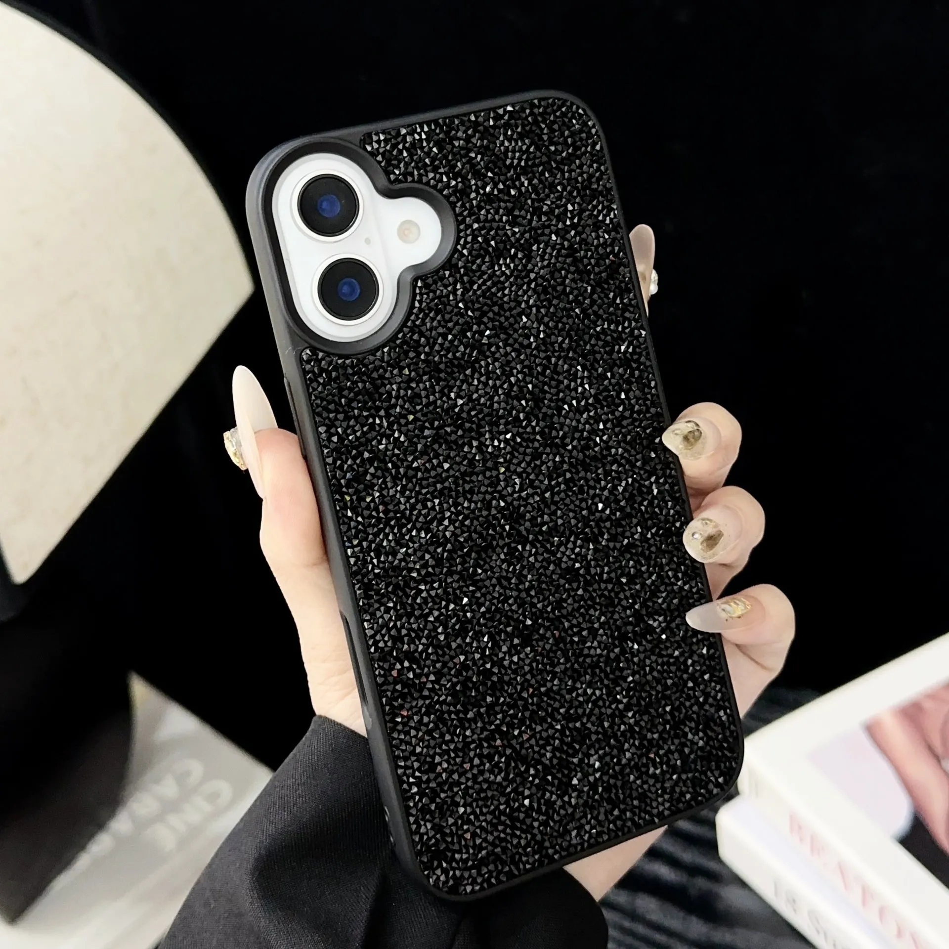 Skin Feeling Carbink phone case for iPhone 14 Pro with large hole cutouts and handmade rhinestone decorations in white, black, and pink colours