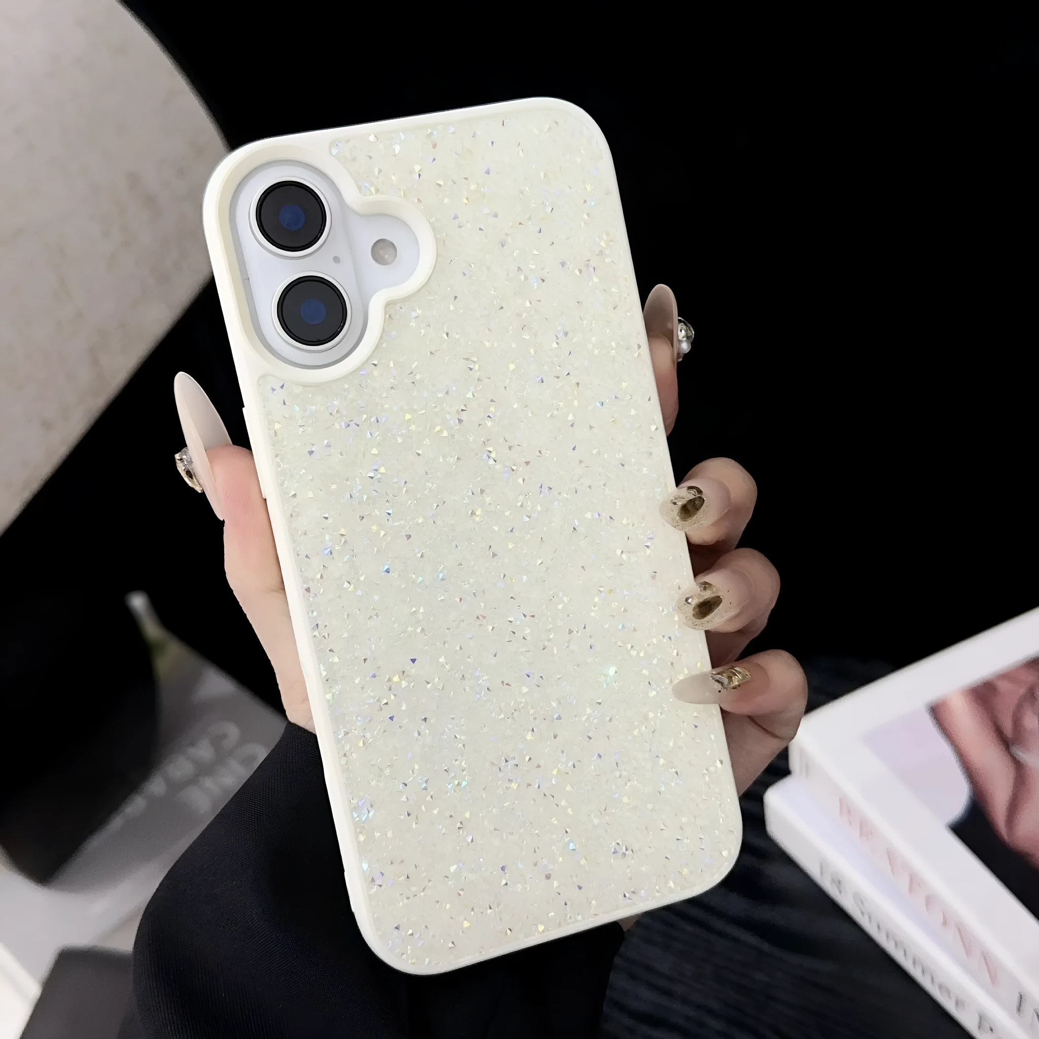 Skin Feeling Carbink phone case for iPhone 14 Pro with large hole cutouts and handmade rhinestone decorations in white, black, and pink colours