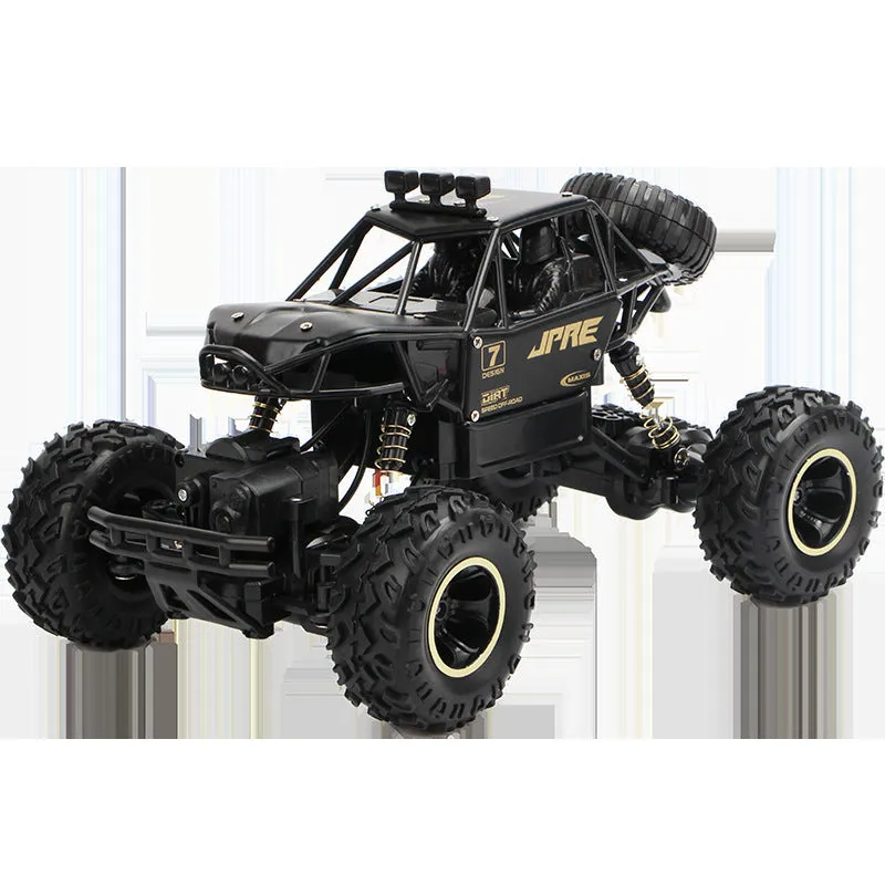 Black and silver remote control off-road car on rough terrain showing four-wheel drive and climbing capability.