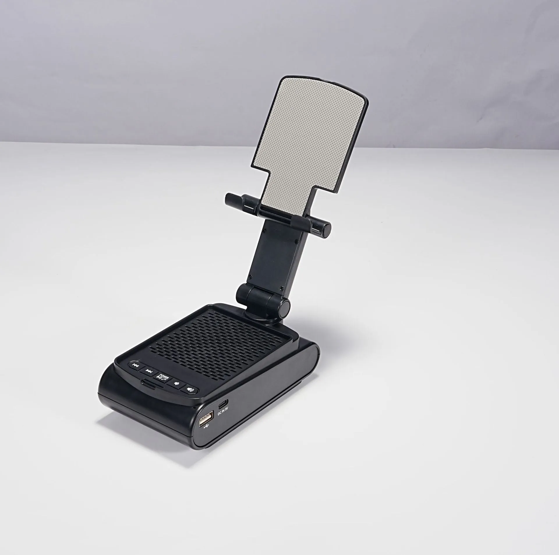 Multi-function lazy phone holder with Bluetooth speaker USB powered black white plastic