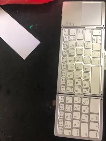 Ultra-thin tri-fold folding touch Bluetooth keyboard shown in both folded and open positions