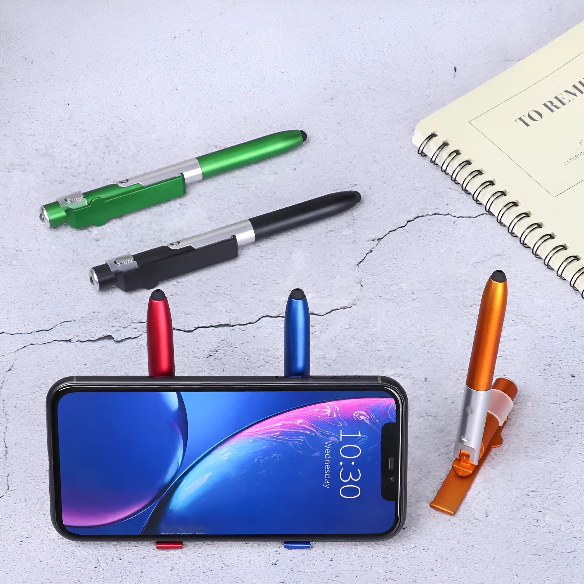 4-in-1 folding light pen mobile phone holder showing pen, phone stand, and LED light functions