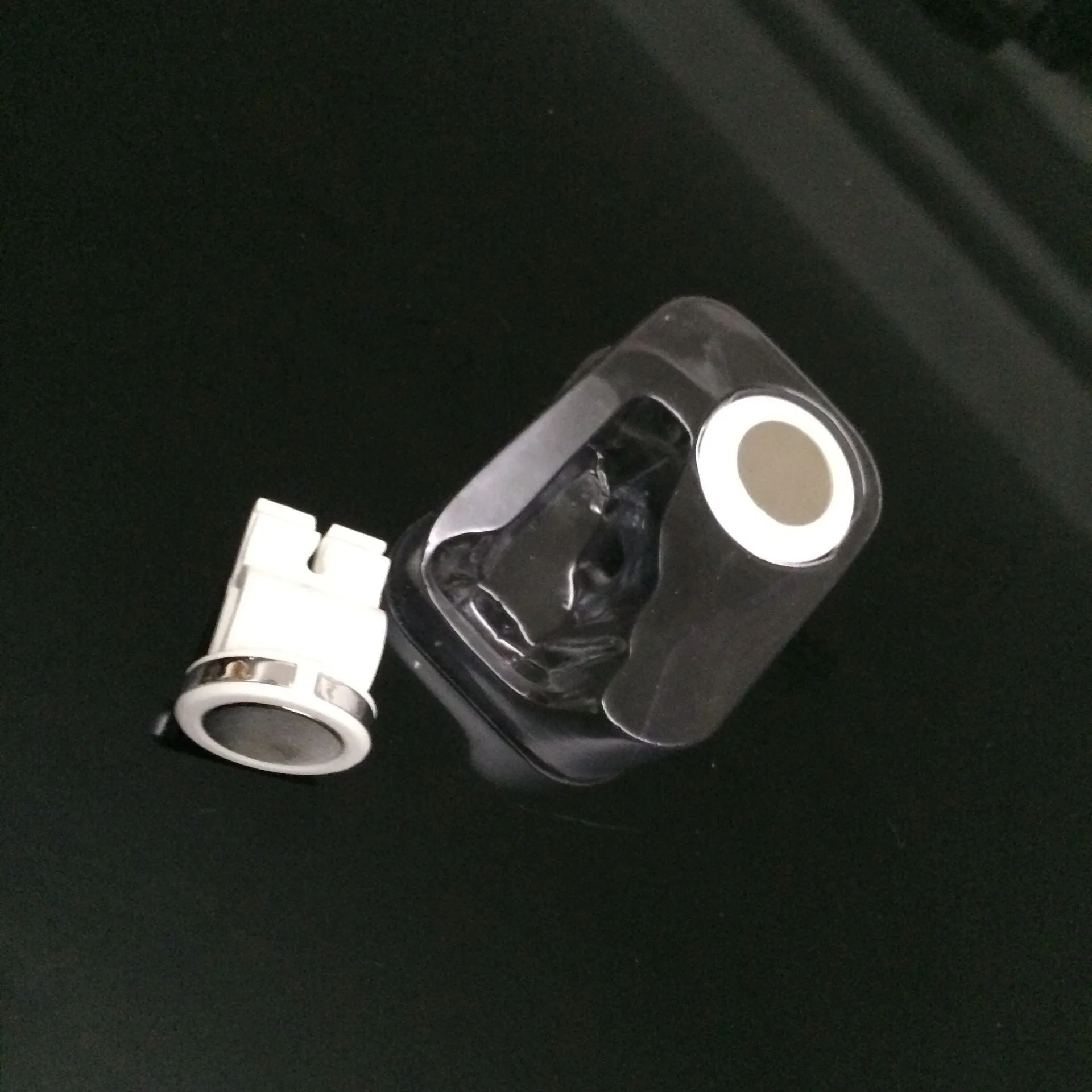 Mini white magnetic car phone holder clipped on car air vent showing compact 3cm size