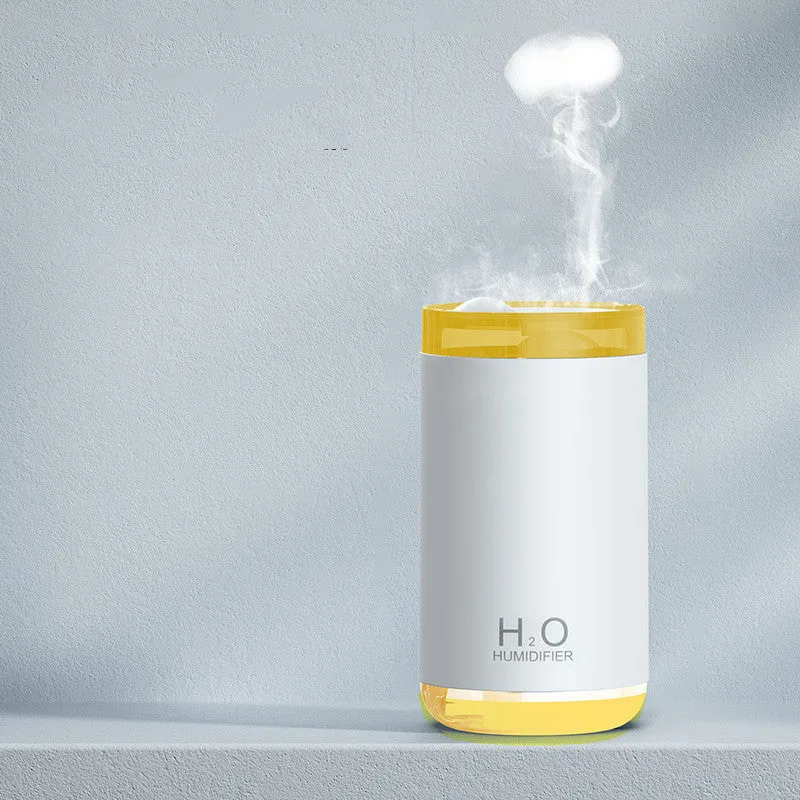 White jellyfish-shaped USB humidifier with warm night light on wooden surface