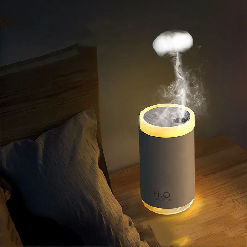 White jellyfish-shaped USB humidifier with warm night light on wooden surface