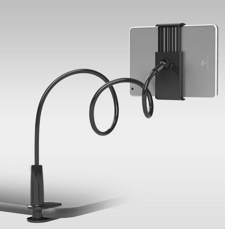 Black bedside oversize phone stand with a long adjustable arm on a wooden table.