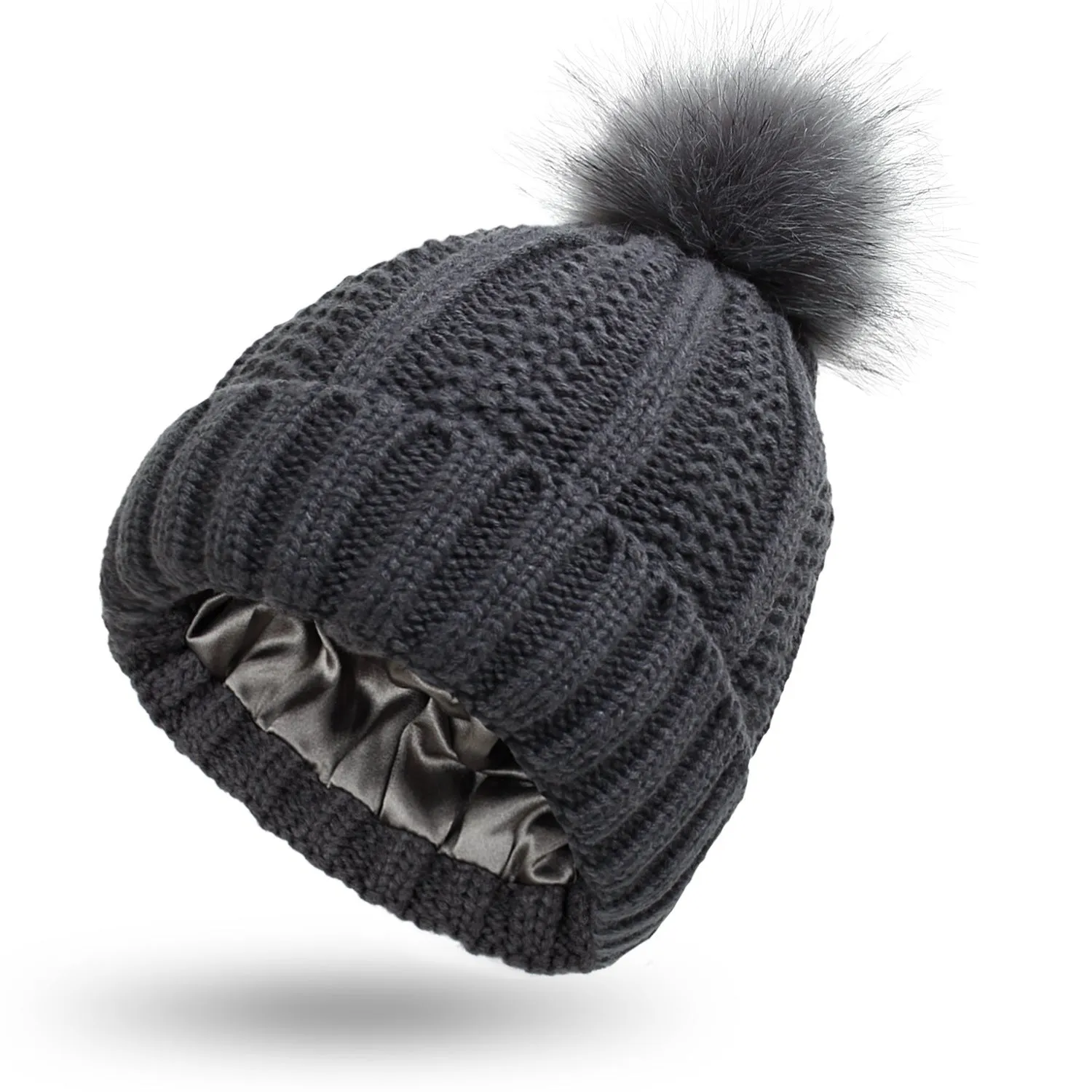 Women's knitted beanie hat with faux fur pom pom and satin lining in multiple colour options.