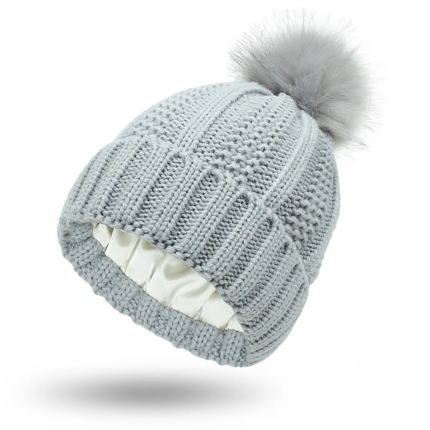 Women's knitted beanie hat with faux fur pom pom and satin lining in multiple colour options.