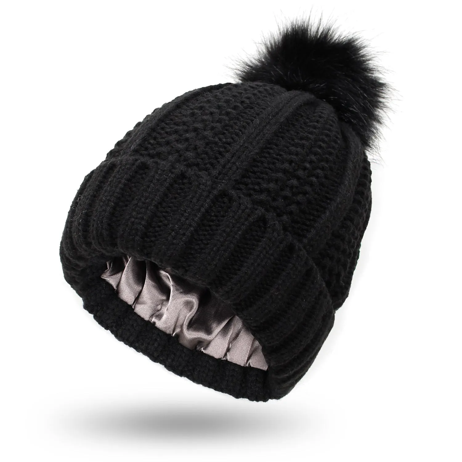 Women's knitted beanie hat with faux fur pom pom and satin lining in multiple colour options.