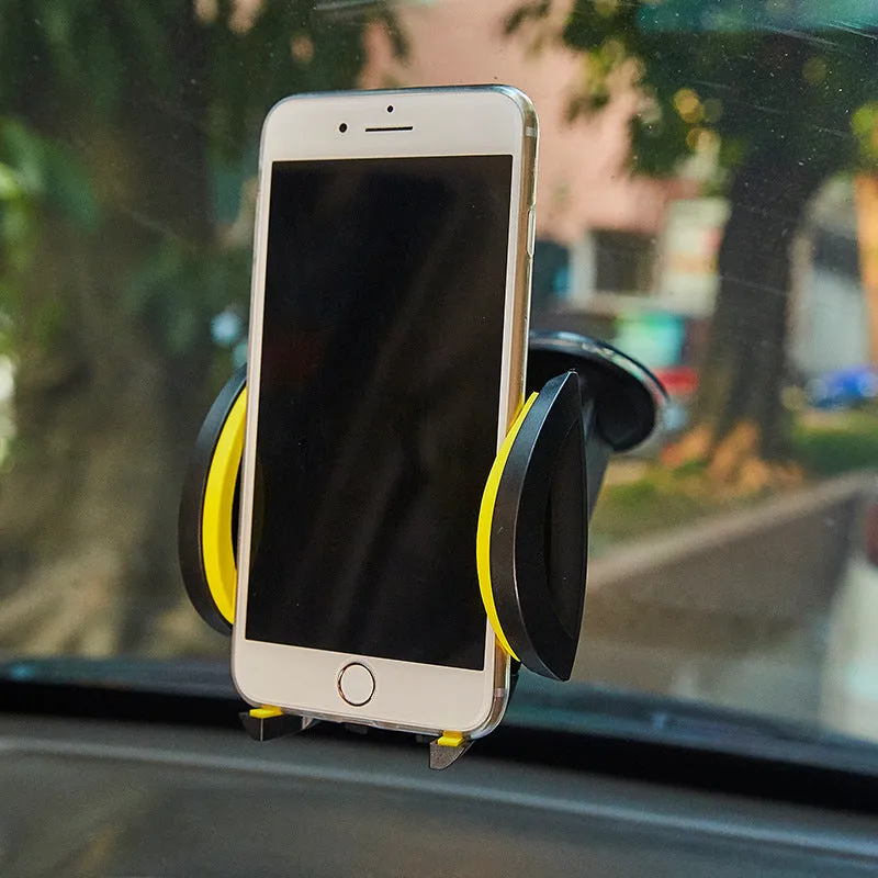Red ABS car phone holder with U-shaped bracket and suction cup mount on a dashboard.