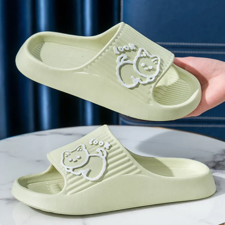 Women's pink EVA cat slippers with thick platform sole on a wooden floor.