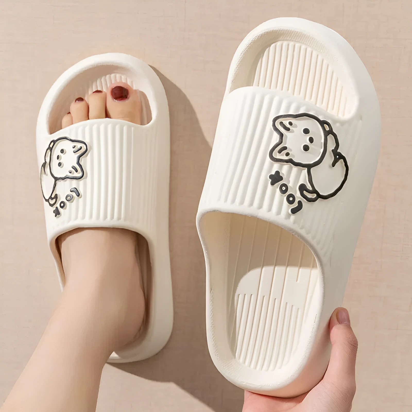 Women's pink EVA cat slippers with thick platform sole on a wooden floor.