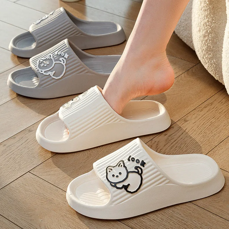 Women's pink EVA cat slippers with thick platform sole on a wooden floor.