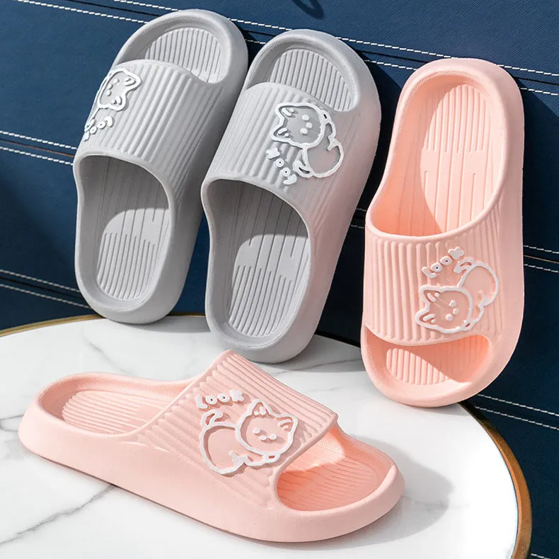 Women's pink EVA cat slippers with thick platform sole on a wooden floor.