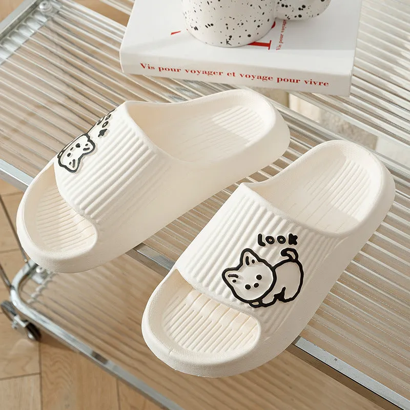 Women's pink EVA cat slippers with thick platform sole on a wooden floor.