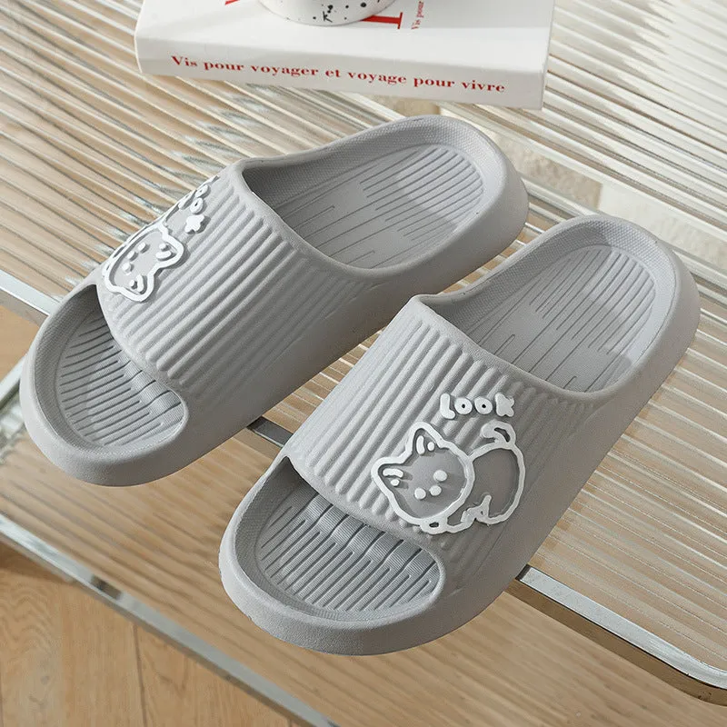 Women's pink EVA cat slippers with thick platform sole on a wooden floor.
