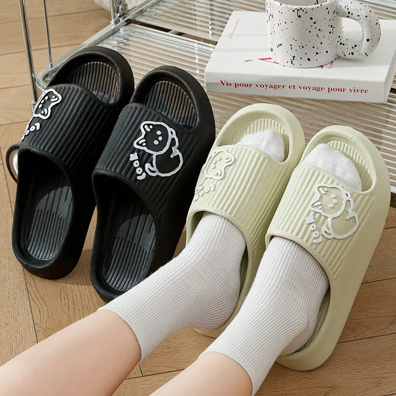 Women's pink EVA cat slippers with thick platform sole on a wooden floor.