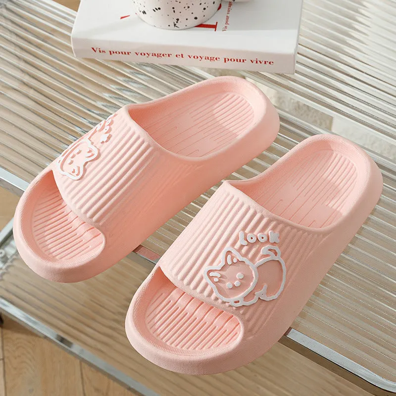 Women's pink EVA cat slippers with thick platform sole on a wooden floor.