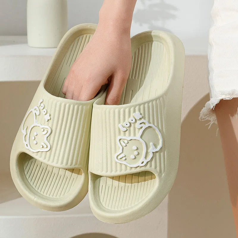 Women's pink EVA cat slippers with thick platform sole on a wooden floor.